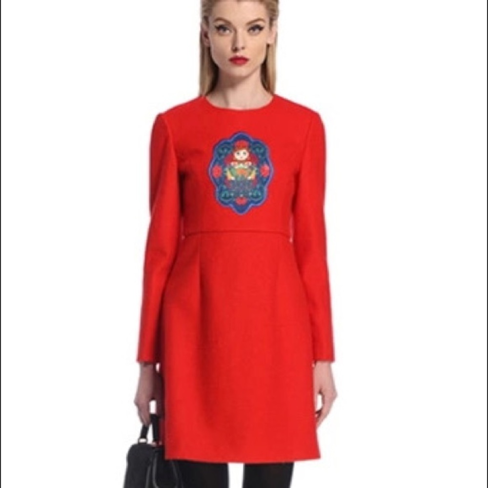 Unique red dress with ethnic doll decorations